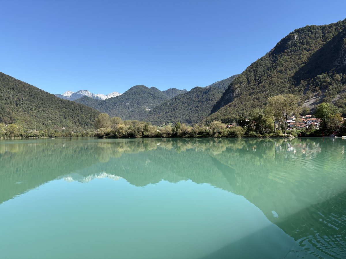 A lake with the colour of the Soca river and the Alps in the background.. A lake with the colour of the Soca river and the Alps in the background..