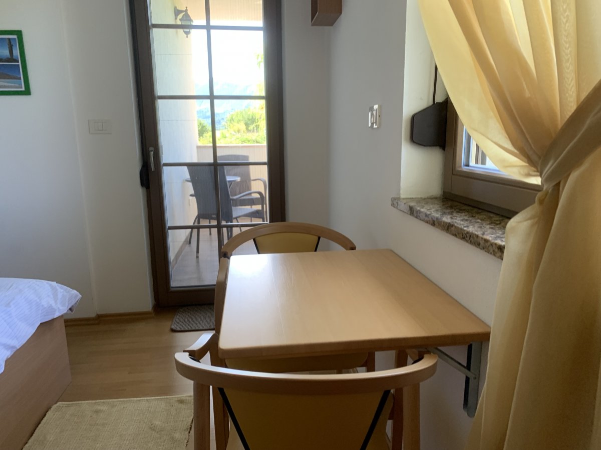 hand made wooden folding table and door with insect screen leading out to the balcony.. hand made wooden folding table and door with insect screen leading out to the balcony..