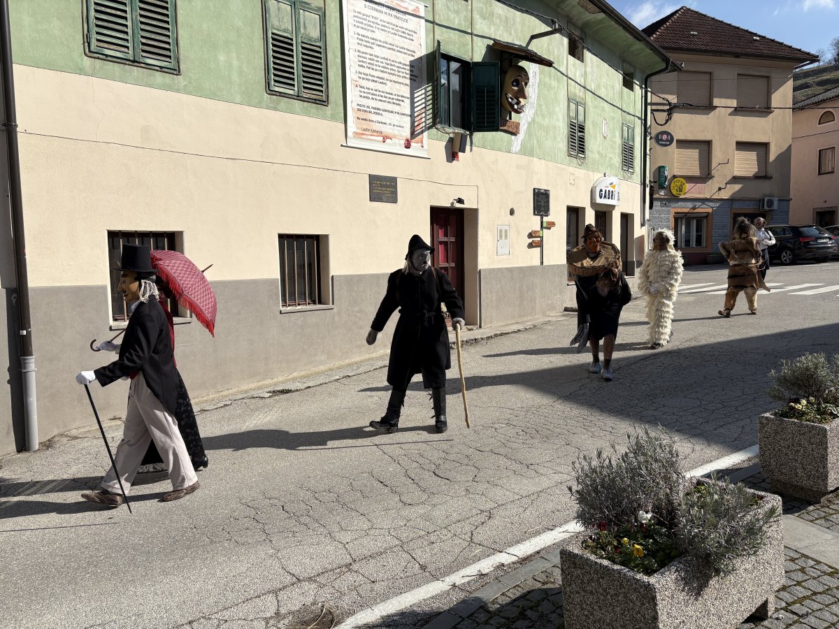 the Cerkno Laufarija characters exit their den in strict order on the way to the village centre..
