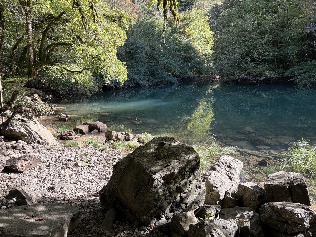 The water was bubbling up from under these rocks and flowing into the main river at this beach..